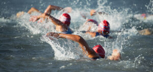 Competitors swimming out into open water at the beginning of tri