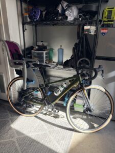 The Batch GB.1 gravel bike hanging in a home garage alongside other bikes and gear.