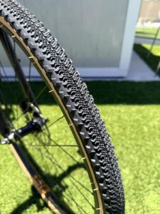 Close-up of the Batch GB.1 700x42mm gravel tire tread, a fast-rolling center with cornering knobs and a tan sidewall.