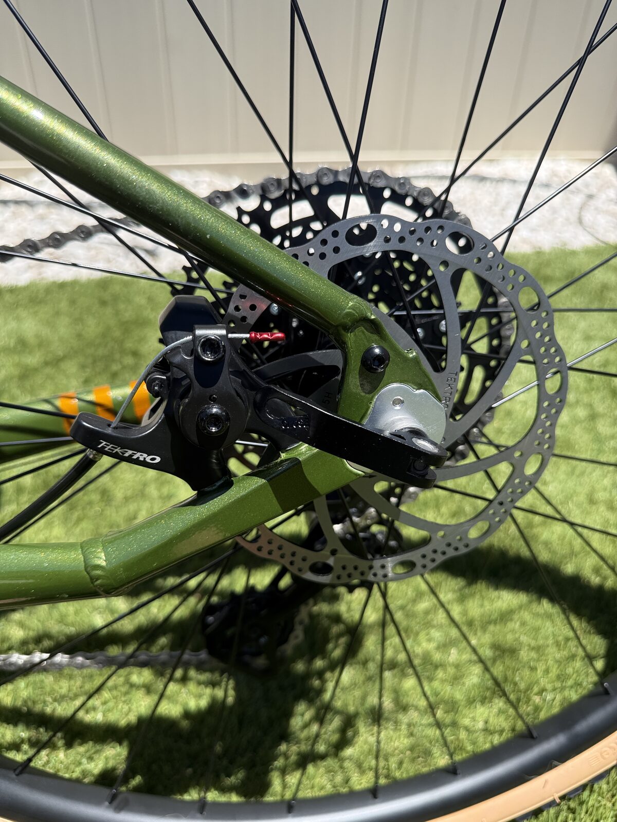 Batch GB.1 rear Tektro mechanical disc brake caliper and 160mm rotor at the dropout.