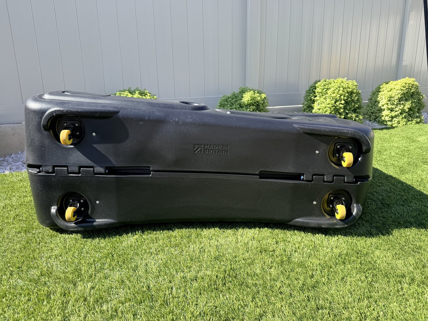 Underside of the Shokbox Pro showing four multi-directional castors and the hinge spine